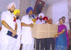Punjab sports minister Gujar Singh Ranike hands over sports meterial to the district sports officer in Amritsar on Tuesday.