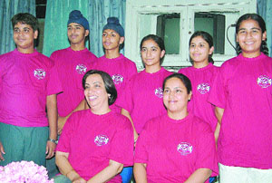 Students and staff members of the school address a press conference in Jalandhar