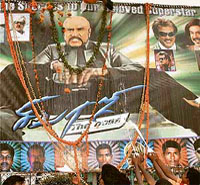 Fans of Tamil super star Rajnikant celebrate the release of his movie Sivaji by pouring milk and flowers at a hoarding in Bangalore on Friday.