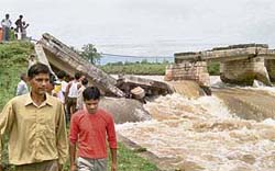 Onlookers throng a bridge on the Beas canal in Kala Chhak village at Sujanpur that collapsed on Friday morning.