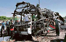 The Afghan police inspects the bus after a bomb blast in Kabul on Sunday.