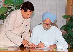Prime Minister Manmohan Singh signs the nomination form for Pratibha Patil, the ruling Congress-led government candidate for the forthcoming Presidential elections, as union information and broadcasting minister Priyaranjan Dasmunshi looks on in New Delhi