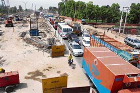 Vehicles move at a snail’s pace on National Highway No. 1 in Panipat where the construction of a flyover is underway