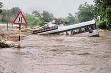 A bus caught in the flash floods at Prakasham district in Andhra Pradesh on Friday. 