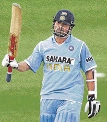 Sachin Tendulkar raises his bat on reaching the 15,000-run mark in ODIs during the second one-dayer against South Africa on Friday. Tendulkar, playing in his 387th one-dayer, became the first batsman in cricket history to reach the landmark.