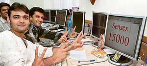 Brokers at a Mumbai brokerage house are all smiles as Sensex touched the 15,000 mark.