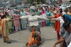 Workers from Jalandhar and Kapurthala burn effigy of PM Manmohan Singh on Tuesday.