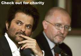 Actor and goodwill ambassador of Plan India Anil Kapoor listens to a question from the media as Country Director Plan India Roland Angerer (right) looks on at a press conference in New Delhi.