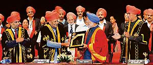 Prime Minister Manmohan Singh receives the degree of doctor of letters (honoris causa) of the University of Jammu from Governor and chancellor S.K. Sinha in Jammu on Sunday.