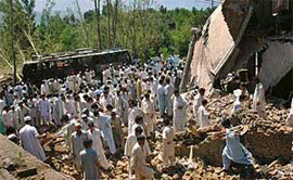 Residents gather at the site of a suicide bombing in Matta town of Swat in North West Frontier Province on Sunday.