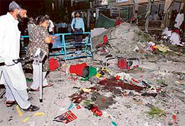 A Pakistani woman weeps over the body of an activist of the Pakistan People's Party at the blast site in Islamabad on Tuesday.