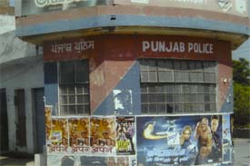 A police post in the city lies defaced with film posters.