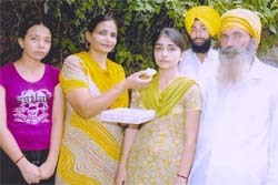 Prabhjit Kaur along with her family members celebrates her achievement.