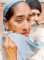 The wife of Shamsher Singh, who was awarded life term in Beant case, cries after hearing the judgment outside Burail jail in Chandigarh