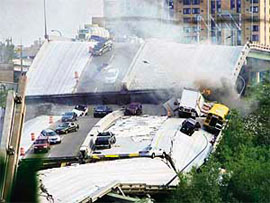 Vehicles are scattered along the broken remains of the interstate 35W bridge, which stretches between Minneapolis and St Paul, after it collapsed into the Mississippi River during evening rush hour on Wednesday, sending vehicles, tons of concrete and twisted metal crashing into the water.