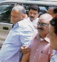 Ashok Malhotra, main accused in the multi-crore land scam in national Capital, being taken by CBI officials after he surfaced in the studio of a private news channel in New Delhi