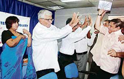 Mayhem at Taslima function: Bangladeshi novelist Taslima Nasreen (left) takes shelter behind an organiser as activists from Majlis-e-Ittehadul Muslimeen (MIM) disrupt a meeting at a Press Club in Hyderabad, on Thursday.