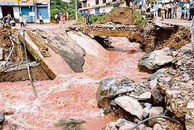 A bridge in the Industrial Area, Parwanoo, in Himachal Pradesh collapses following a cloudburst on Monday.
