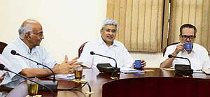 CPM general secretary Prakash Karat (centre) shares a lighter moment with senior party leaders and politburo members R. Uma Nath (right) and Ramachandran Pillai at the party headquarters as they attend a politburo meeting on the issue of Indo-US nuclear deal in New Delhi on Friday.