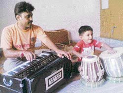 Anil Sharma practising along with his three-year-old son Swra