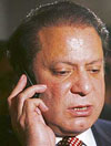 Former Prime Minister of Pakistan Nawaz Sharif speaks on his phone after a news conference in London on Thursday.