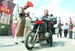 A BSF jawan verifies documents of a foreign national at Wagah checkpost.