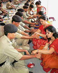 Women tie rakhis to jawans of 62 BSF Battalion in Bikaner on Monday.