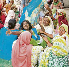 Grief-stricken sister and other family members of Rakesh stage a dharna at Samta Chowk in Gohana on Tuesday.