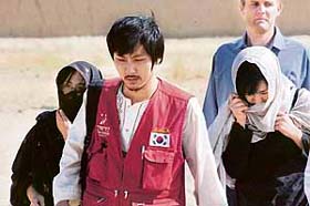 Three South Korean hostages, who had been kidnapped by the Taliban, walk after their release in Ghazni