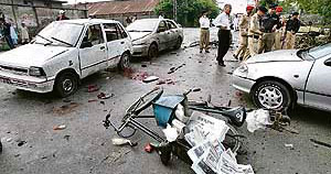 Pakistani army and bomb disposal officials examine the site, which was hit by an explosion in Rawalpindi on Tuesday.