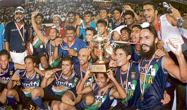 Members of the Indian hockey team pose with the trophy after winning the 7th Asia Cup in Chennai