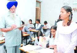 Ajit Singh teaches students of Citizens Forum Vidya Mandir School in Maqboolpura in Amritsar