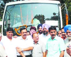 Mayor Shawet Malik flags off trial run of the city bus service which will start