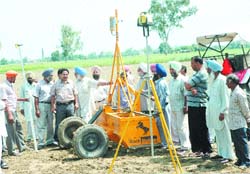 Farmers being told about the benefits of laser leveller machine at Madaar village in Aadampur subdivision on Tuesday.