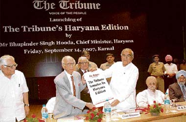 The Chief Minister of Haryana, Mr Bhupinder Singh Hooda, unrolls a scroll to formally launch the Haryana edition of The Tribune in Karnal