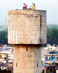 EGS teachers atop a water tank, demanding the release of their colleagues, in Kapurthala on Tuesday.