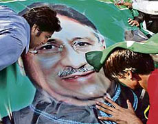 Supporters of President Pervez Musharraf kiss their leaders portrait as they celebrate a Supreme Court verdict allowing him to contest the Presidential election, in Islamabad on Friday.