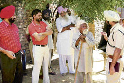 Anil Garg, SDM, Talwandi Sabo, and senior police officials inspect the spot where Gurjant Singh set himself and other family members on fire in a village in Bathinda district on Saturday night. 