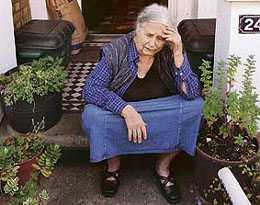 British writer Doris Lessing holds her head in her hands outside her home in north London, on Thursday, as she is told by photographers that she has won the Nobel Literature Prize.