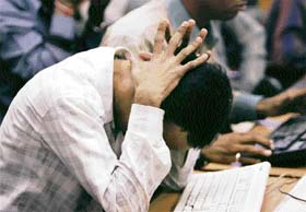 A stock broker reacts at a brokerage firm in Mumbai