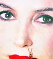 A supporter of Pakistans former prime minister Benazir Bhutto makes a V-sign in front of her picture ahead of her arrival in Karachi