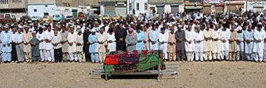 Pakistani mourners pray during a funeral ceremony in Karachi on Friday for two people killed during a suicide attack targeting former Prime Minister Benanzir Bhuttos caravan.