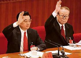 Chinas President Hu Jintao (left) and former President Jiang Zemin vote during the concluding session of the 17th Party Congress at the Great Hall of the People in Beijing