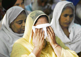 A family member of one of the martyrs sobs at the Punjab Police Martyrs’ Day function at the Police Lines in Bathinda on Sunday