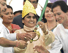 Former union minister Harmohan Dhawan presents a gold crown and a sword to UP Chief Minister Mayawati at a rally in Chandigarh on Sunday.