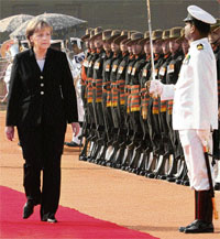 German Chancellor Angela Merkel inspecting a guard of honour on her arrival in New Delhi on Tuesday.