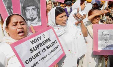 Activists of the All-India Sikh Conference raise slogans during their protest march from Raj Ghat to the Supreme Court, demanding suo motu action against accused of 84 Delhi riots, in New Delhi