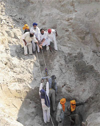 Parma Singhs body being pulled out of a well at Dyal Pura Bhai Ka village in Bathinda on Friday.