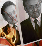 Protestors burn pictures of President Musharraf during a protest against his emergency rule, outside the office of the Pakistan consulate-general in Hong Kong on Tuesday.