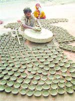 Om Parkash, one of the potter brothers, making diyas.